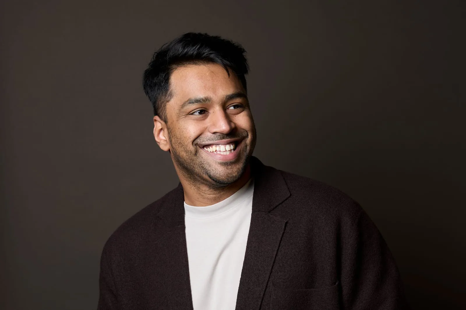 Karthik Mahadevan smiling and looking to the side.