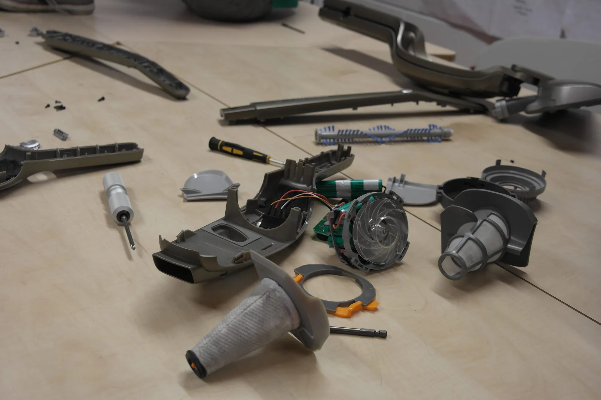 A Dyson V6 taken apart to measure: impeller, cell stack, filter, brush bar and housing.