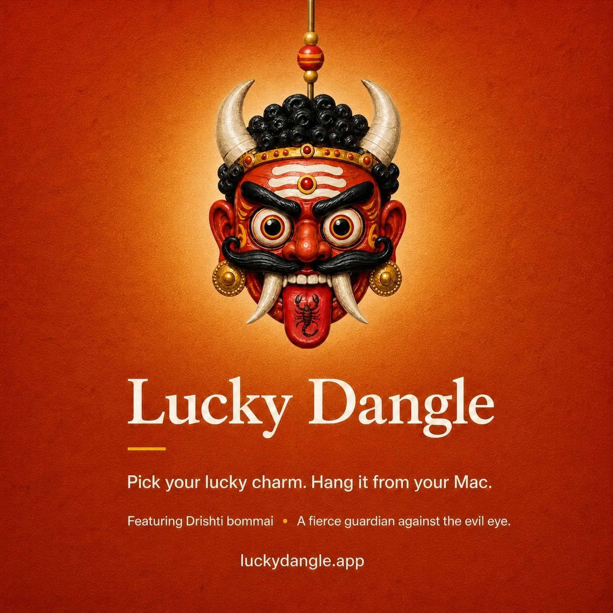 Launch poster for the drishti bommai charm, the fierce mask glowing against temple orange