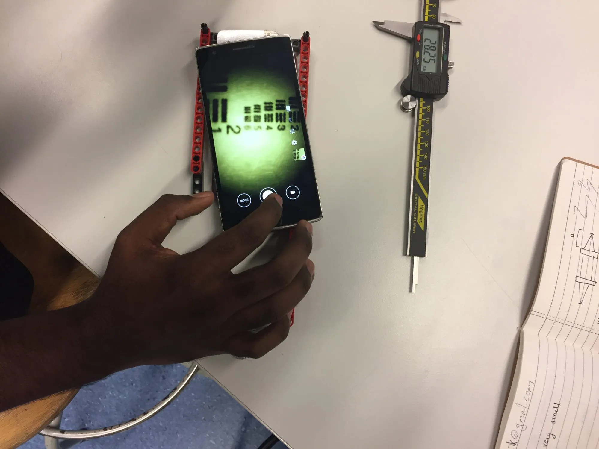 Checking resolution against a test target, with the first optical stack held together in Lego.