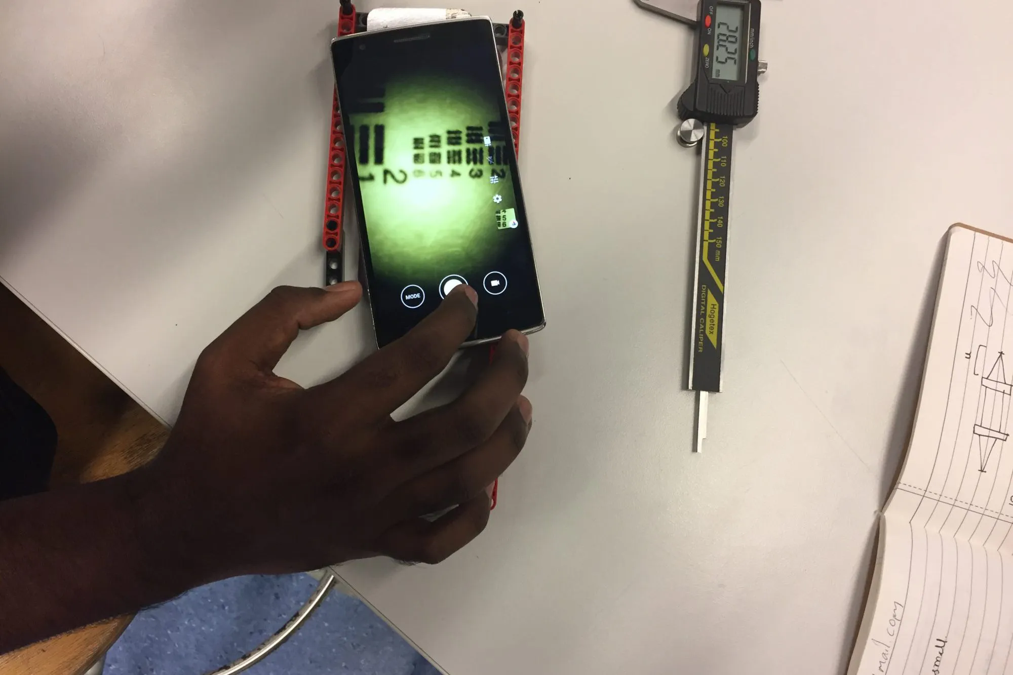 Checking resolution against a test target, with the first optical stack held together in Lego.