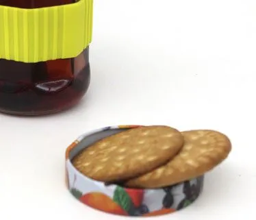 The upturned lid holding two round biscuits like a saucer