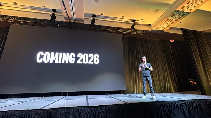Evan Speigel, on a stage, in front of a slide that says “Coming 2026”