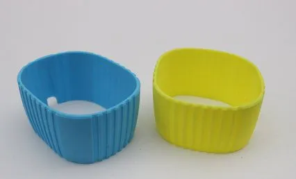 Two ribbed silicone speaker sleeves, one blue and one yellow