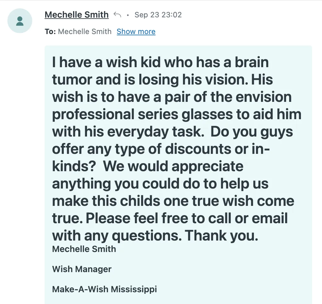 A screenshot of an email from Mechelle Smith, a Wish Manager at Make-A-Wish Mississippi, describing a wish request for a child who has a brain tumor and is losing vision. The wish is for a pair of Envision professional series glasses to help with daily tasks. The email seeks any discounts or donations to fulfill the child’s wish.