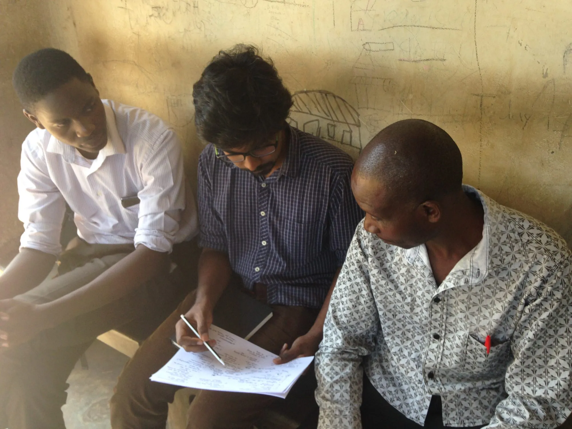 Sitting outside with a village health team, going through a patient's route step by step.