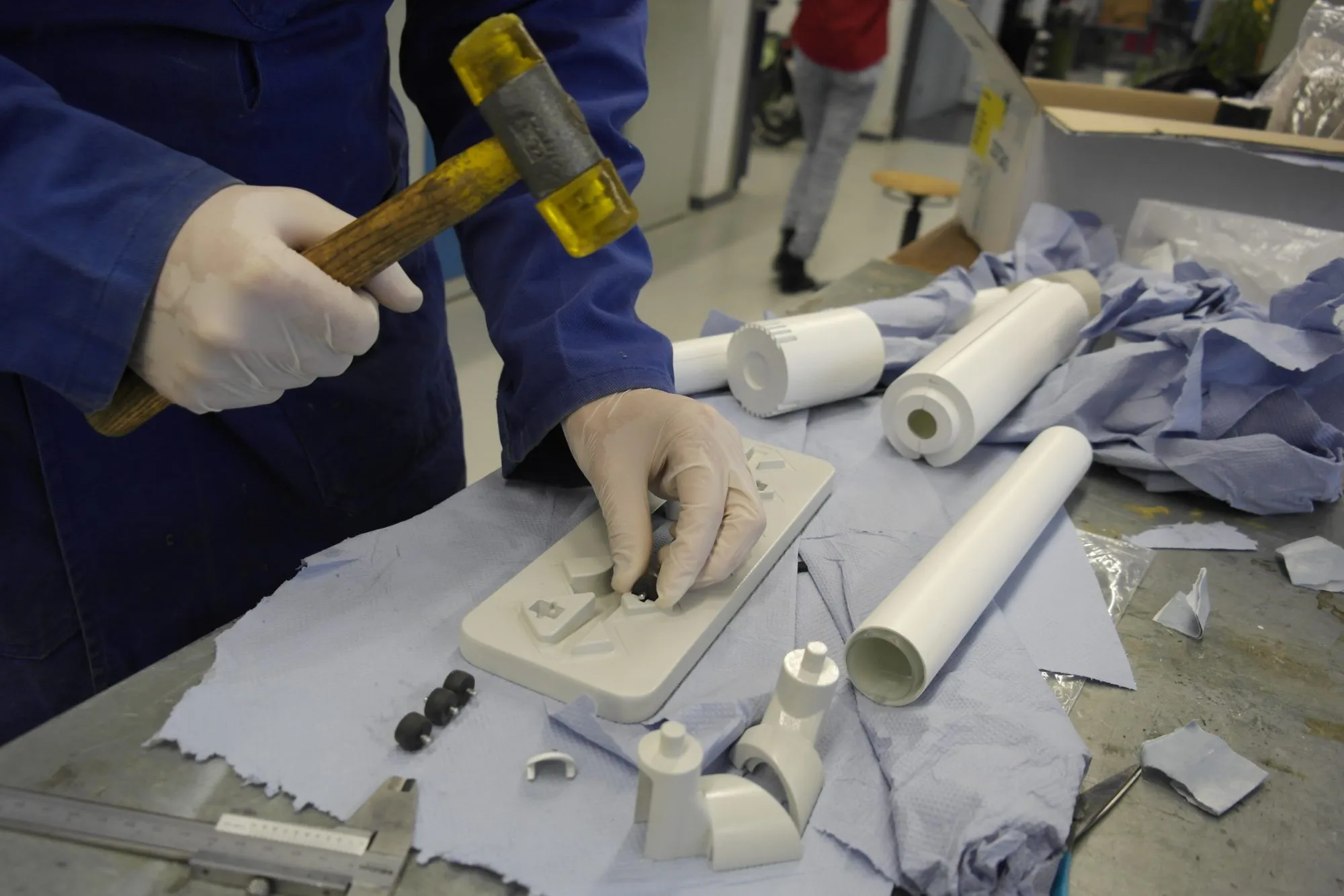 Tapping the wheels into the nozzle plate, with printed tube and joint parts waiting alongside.